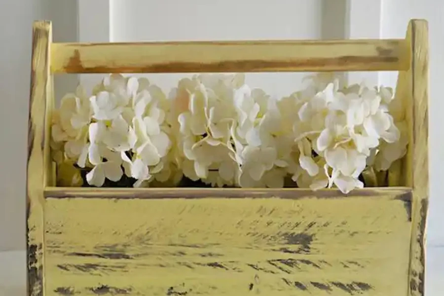Pale yellow distressed rustic toolbox with flowers