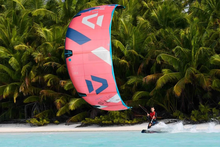 Person controlling a pink surfing kite