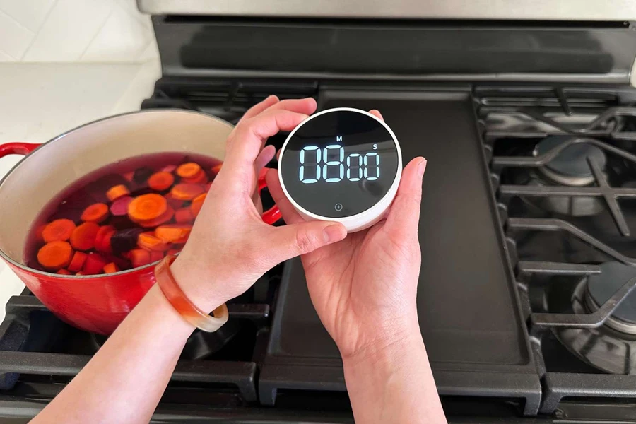Person holding a smart kitchen timer