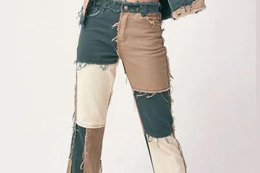 Person wearing multi-colored patchwork jeans