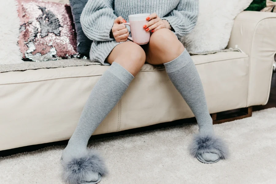 Photo of woman relaxing at cozy home atmosphere on the bed