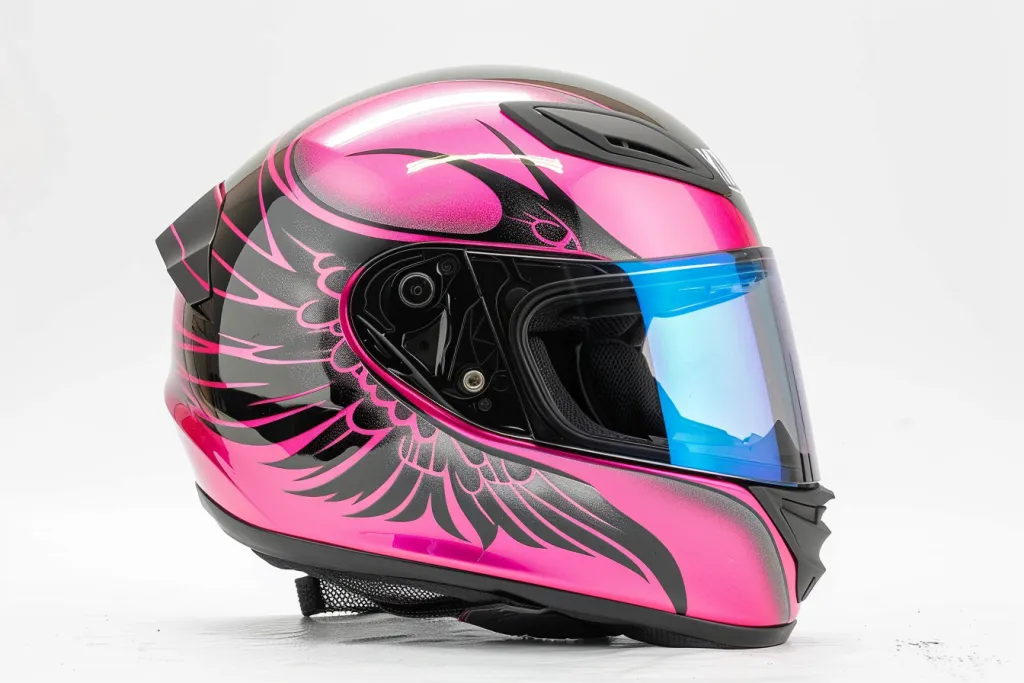 Pink full face motorcycle helmet with black winged design