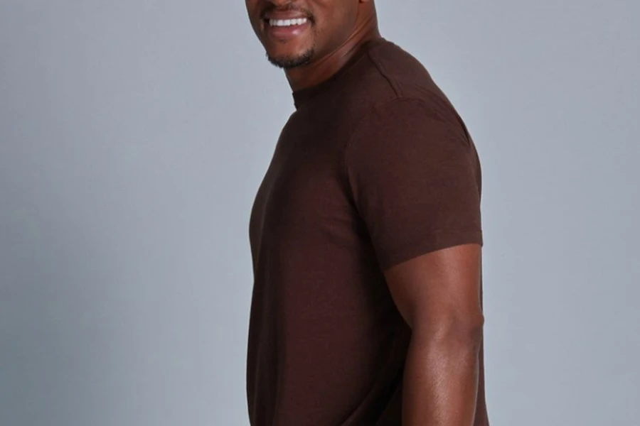 Smiling man in a brown bamboo workout shirt
