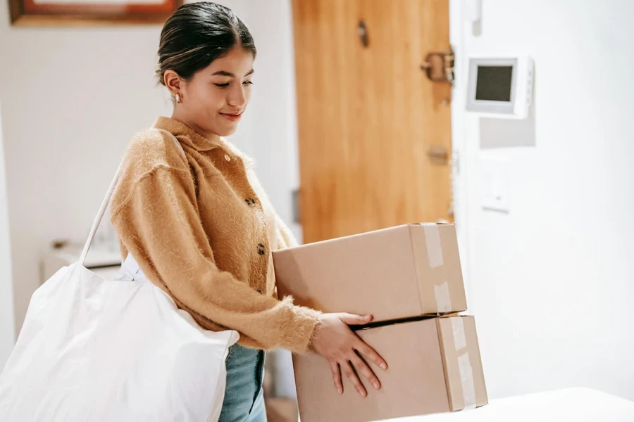 Smiling woman with shopping bag and packed goods