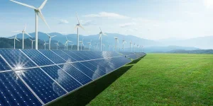 Solar panels and wind generators under blue sky
