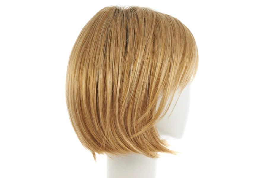Straight hair wig over the white plastic mannequin head isolated over the white background