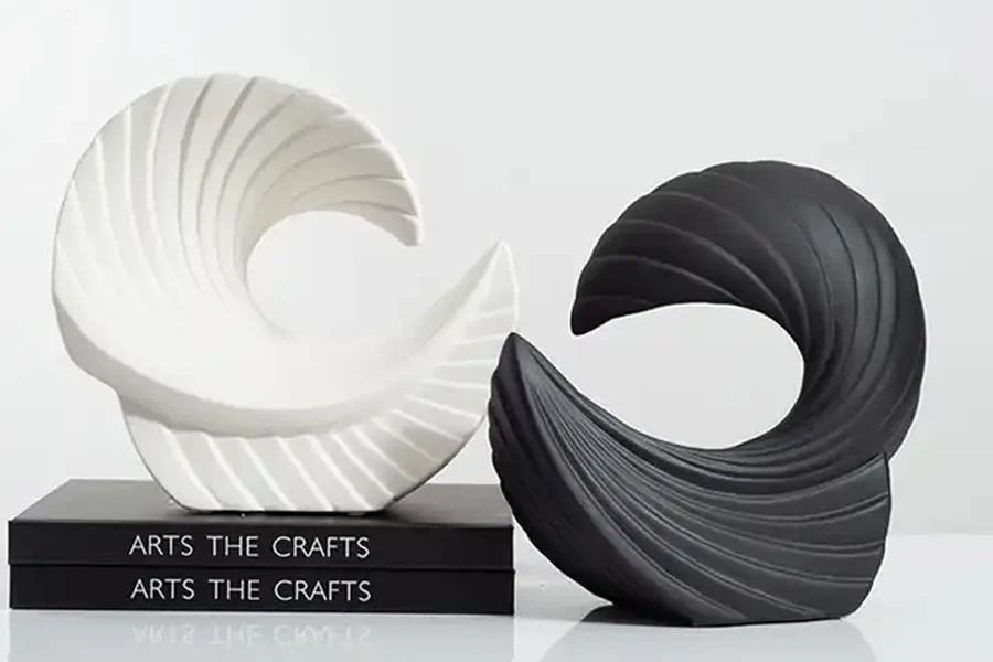 Two abstract white and black coastal or Nordic sculptures