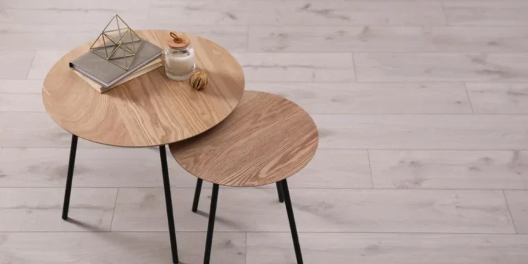Two wooden nesting tables with books and decor