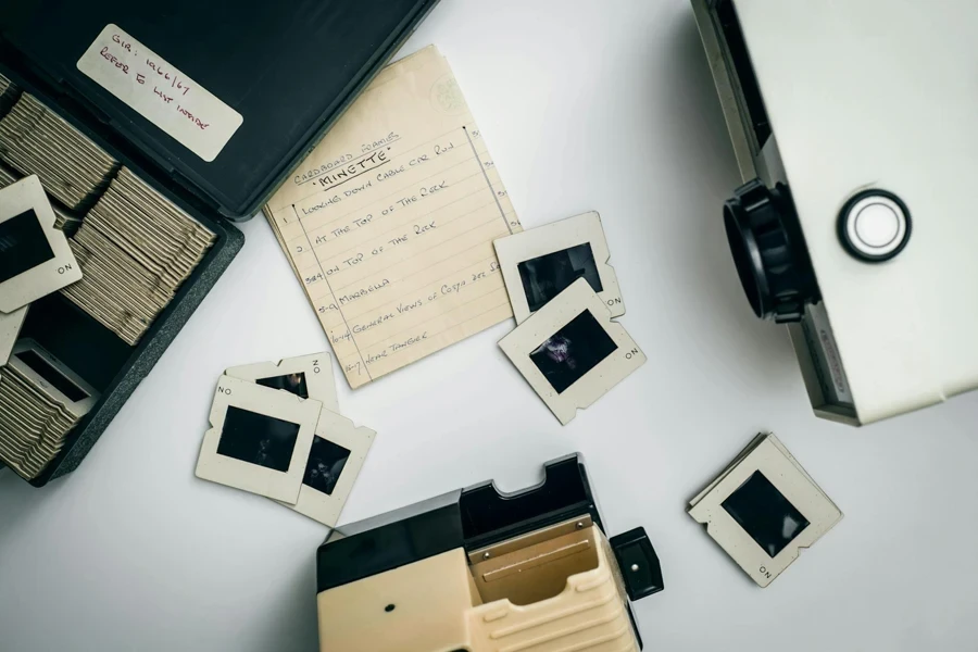 White and Black Projector on White Surface Beside Case