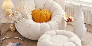 White pumpkin-shaped swivel boucle lounge chair and ottoman