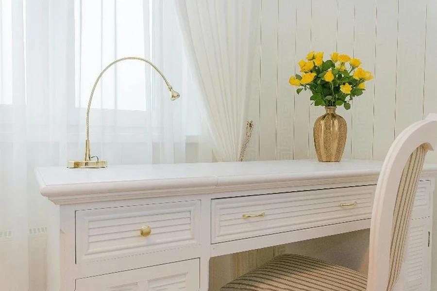 White table with gold adjustable desk light