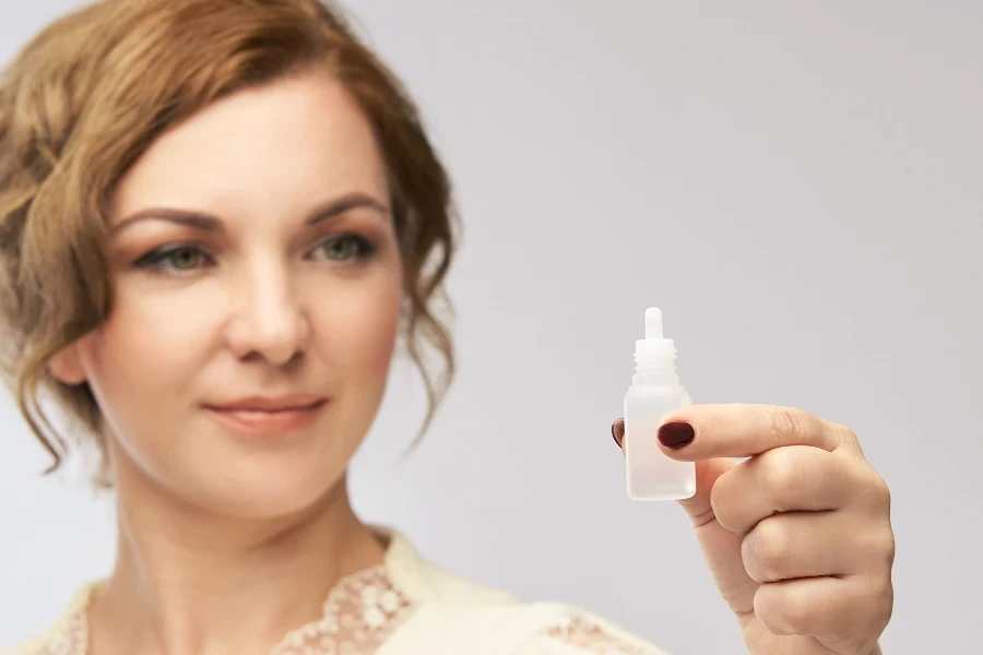 Woman apply eye drops