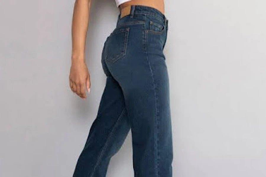 Woman posing in a pair of high-waisted straight jeans