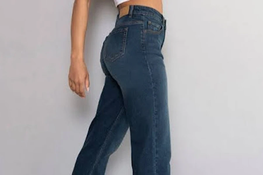 Woman posing in a pair of high-waisted straight jeans