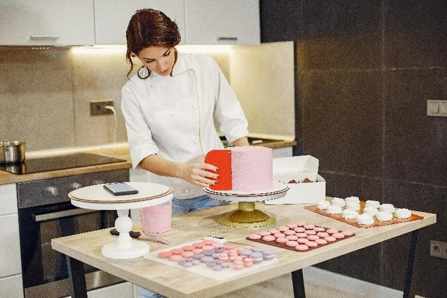 Woman smoothing cake with plastic cake scraper