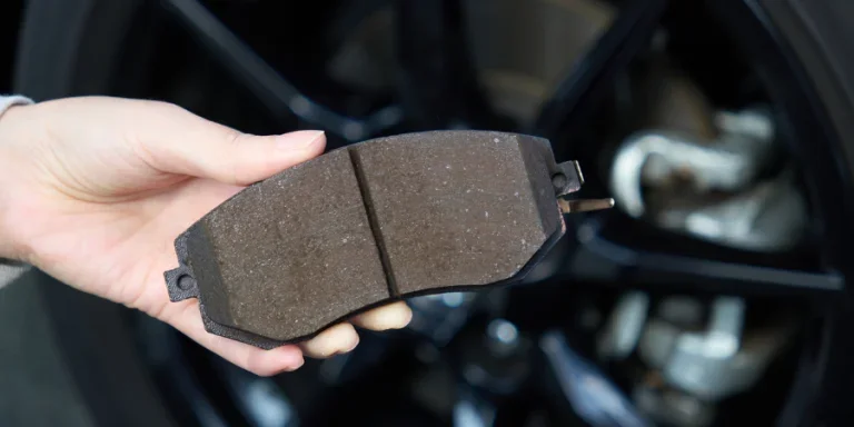 Woman's hand holding brake pad