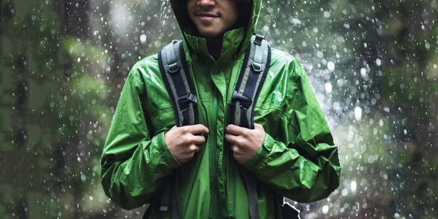 Young Man Hiking in Rain with Waterproof Jacket