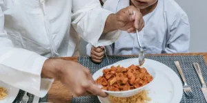 A father and son sharing food during Eid al-Fitr celebrations