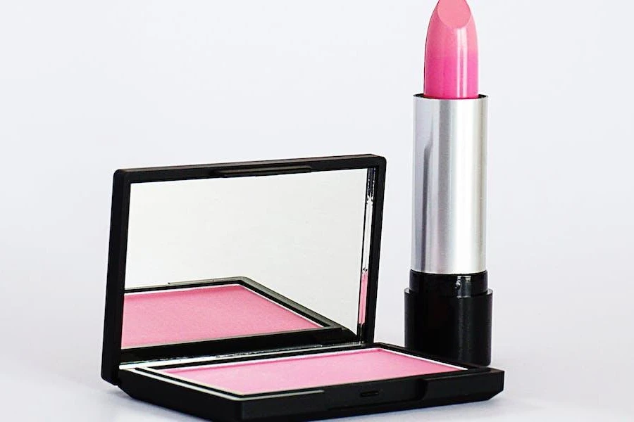 A high-shine lipstick next to a palette