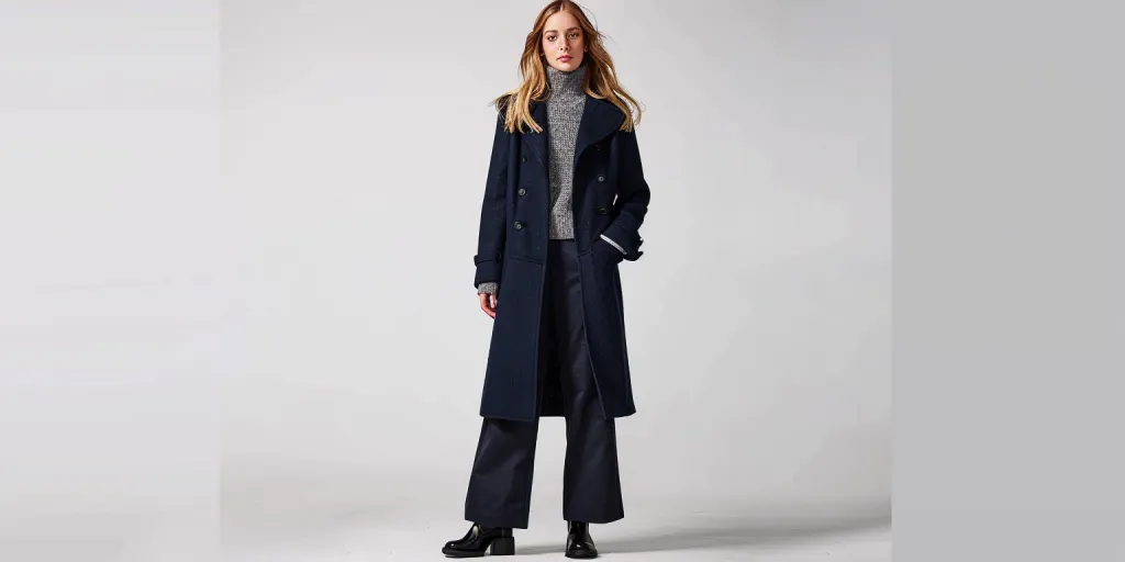 a woman in navy blue wool coat with buttons