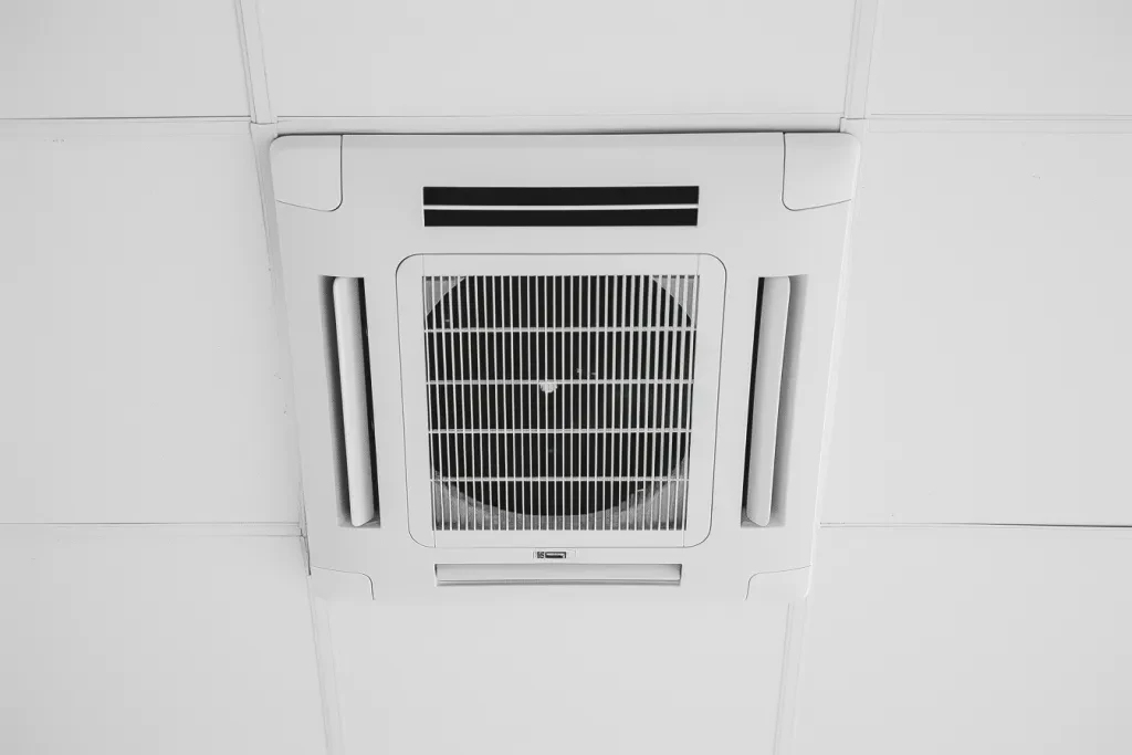 A white ceiling air conditioner with black lines on the top