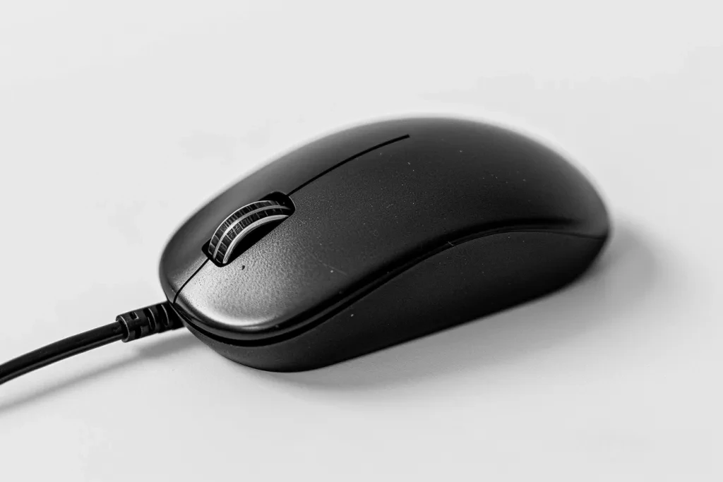 One black computer mouse with a light and long cable