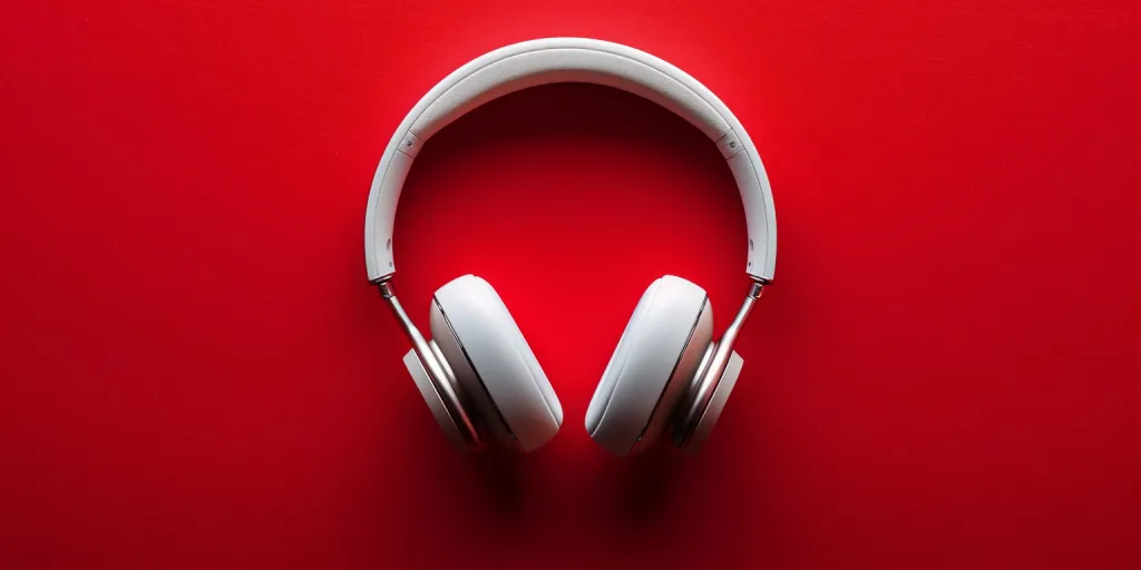 Photo of wireless headphones on red background