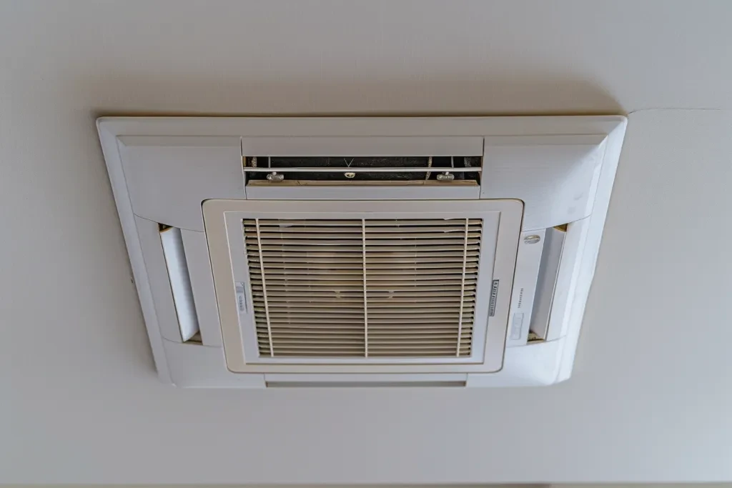 The ceiling of the living room has an opening in which there is one rectangular air conditioner