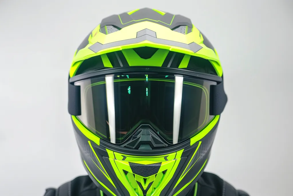 an electric snowmobile helmet with lime green