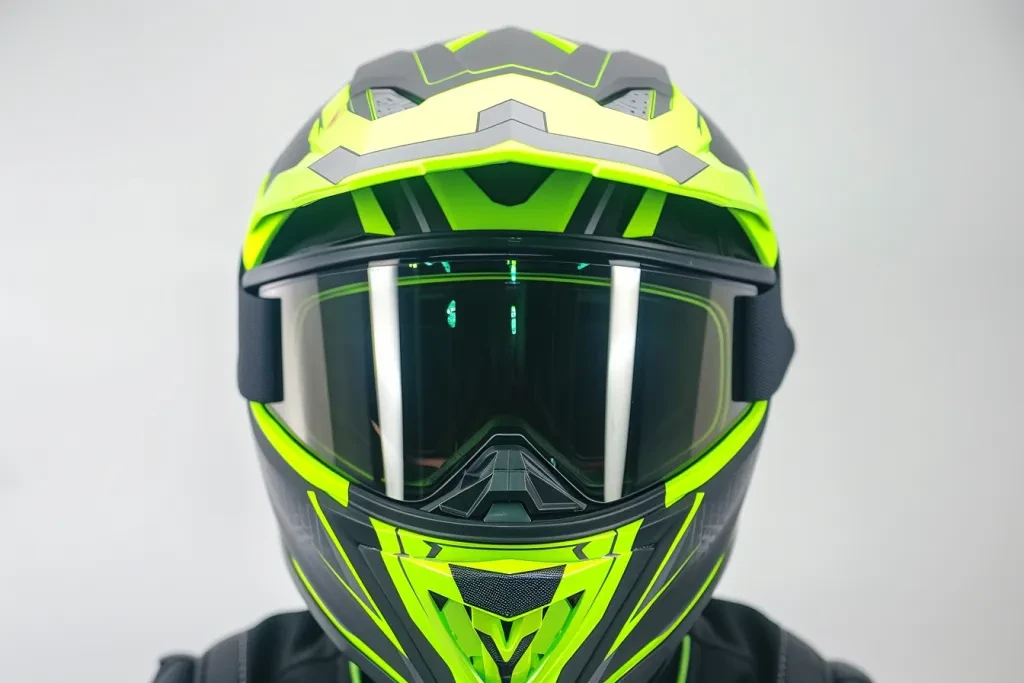 an electric snowmobile helmet with lime green