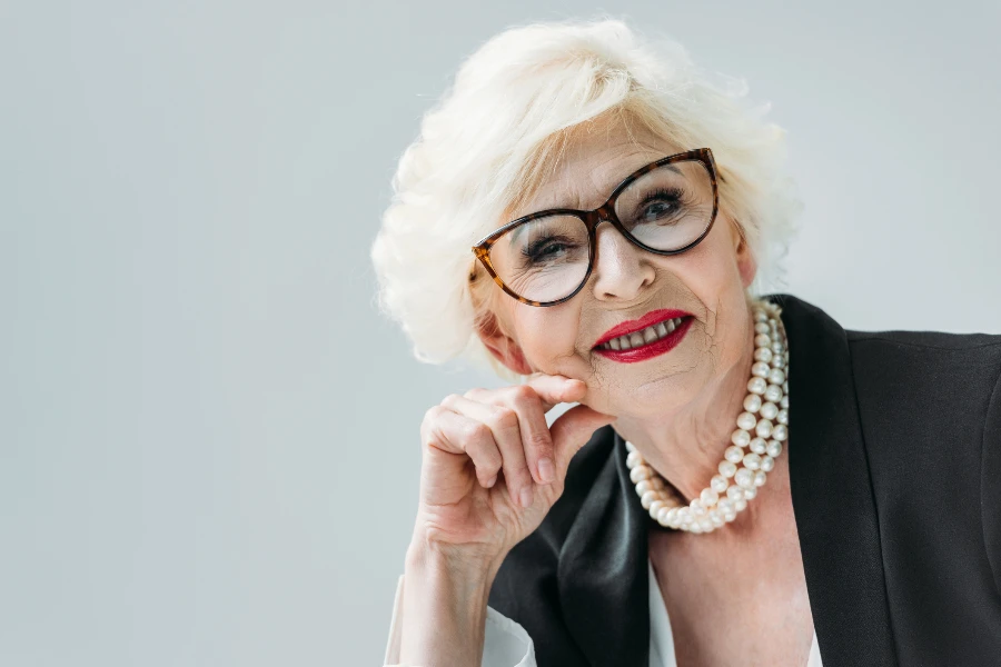 attractive senior lady with pearl necklace and eyeglasses