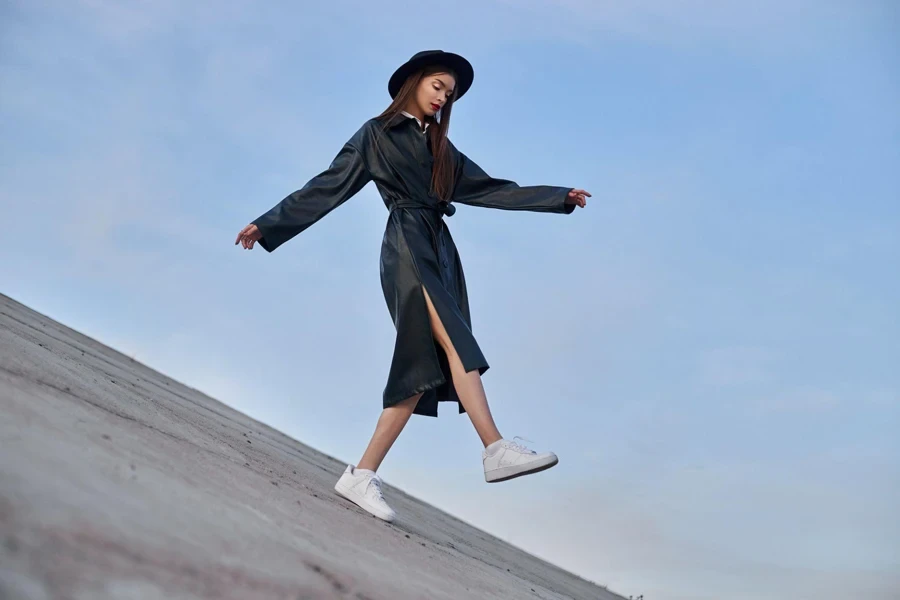 black round hat and leather raincoat