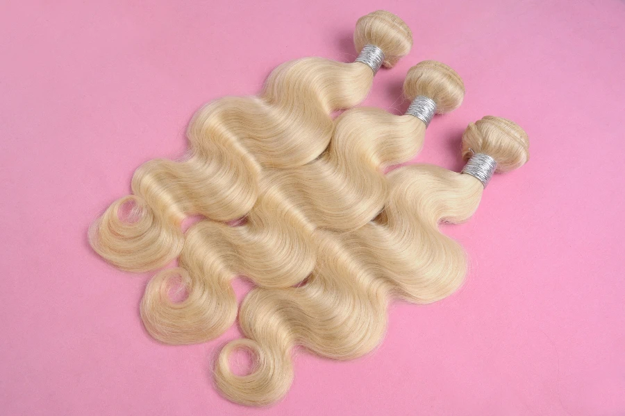 blonde wavy hair on pink background