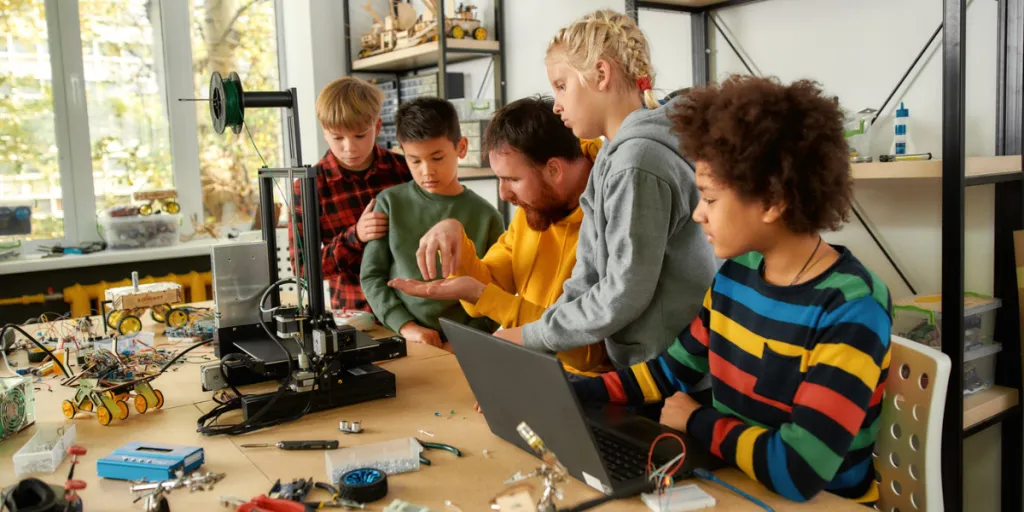 Children learning how to use a 3D printer
