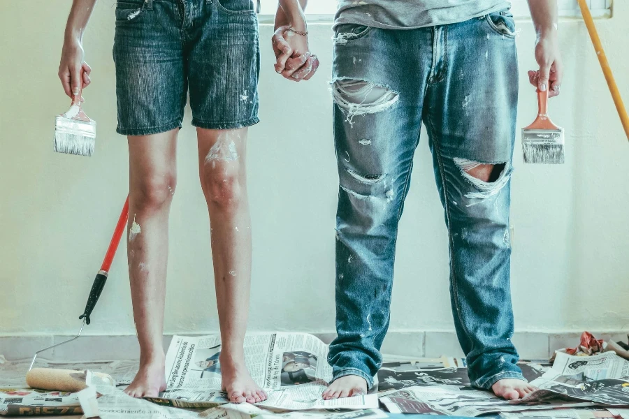 Couple holding hands covered in paint