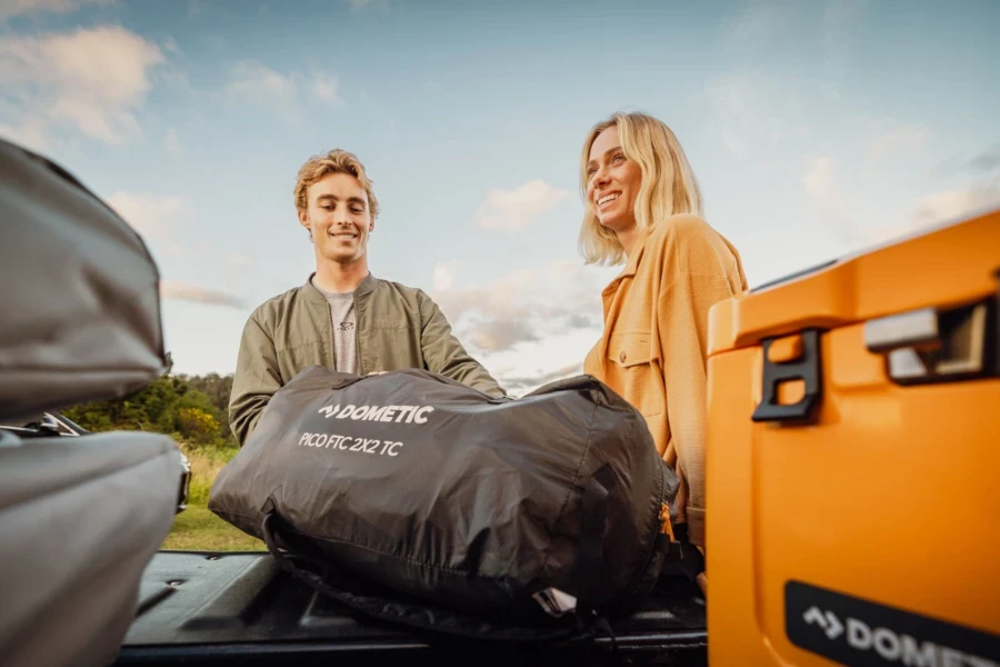 Couple removing soft-sided storage bags