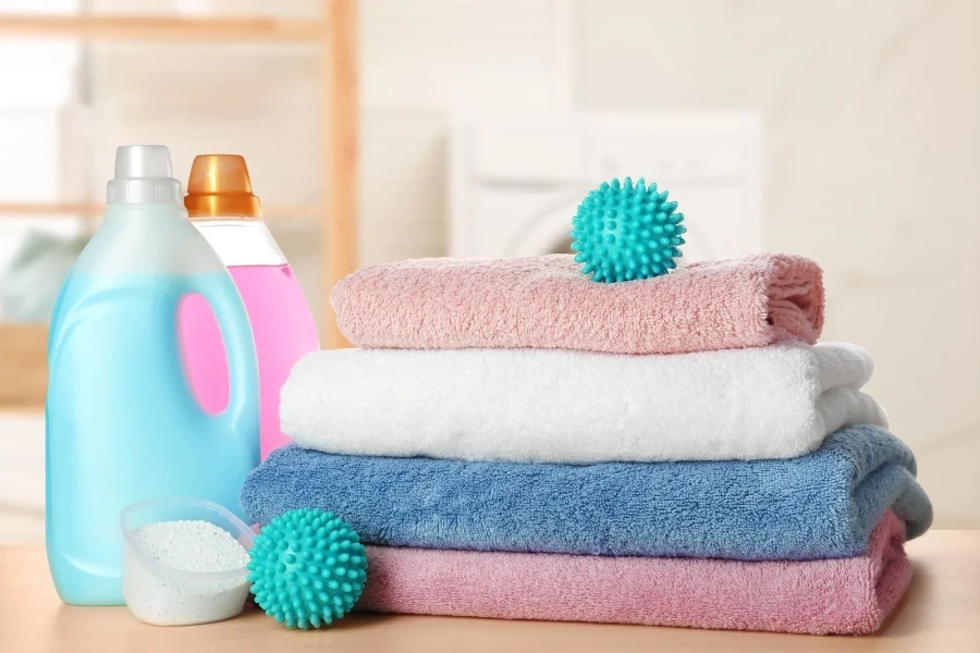 detergent, towels, and dryer balls in a laundry room