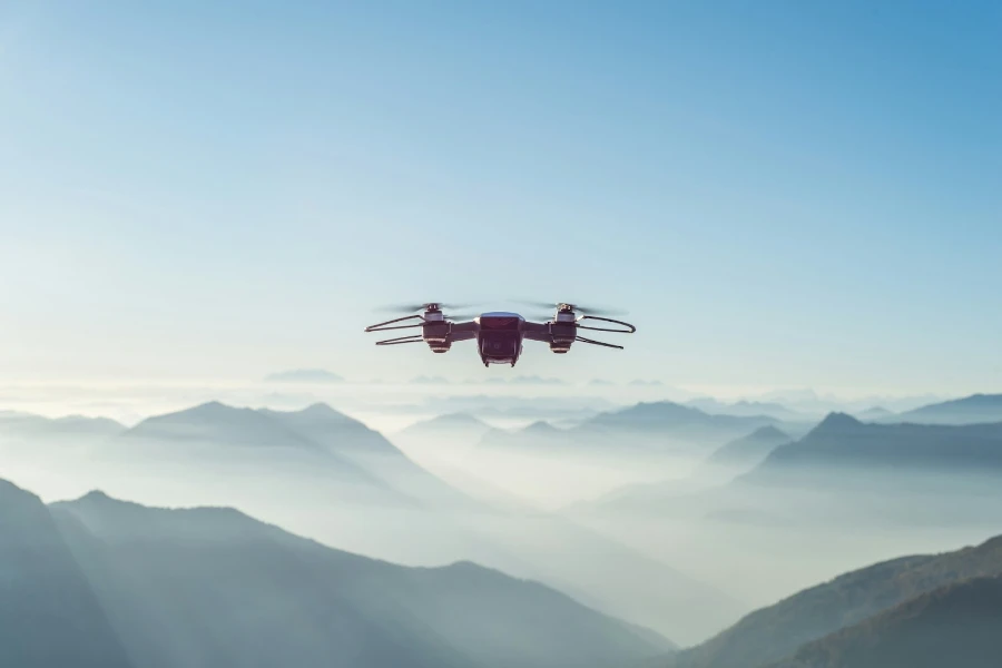 Drone flying high with mountains in the distance
