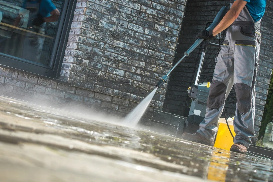 Men Washing Driveway Using Pressure Washer
