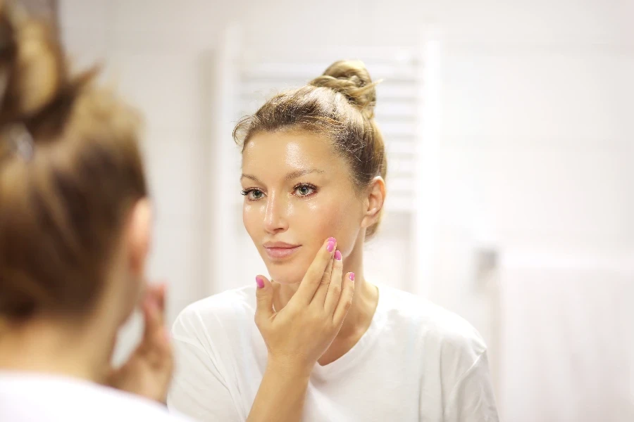 a woman applying the serum
