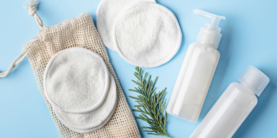 Cotton make-up removal pads and homemade DIY beauty products in reusable bottles