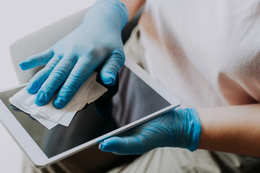 an Chinese female Hands with glove wiping digital tablet