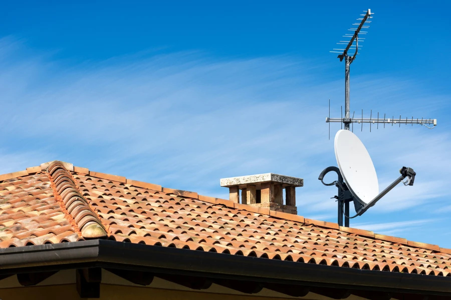 A photo of an outdoor TV aerial and digital waves on the roof