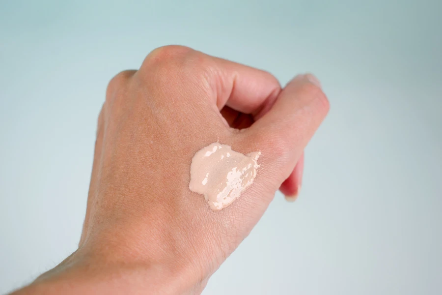 Woman hand with cosmetic foundation
