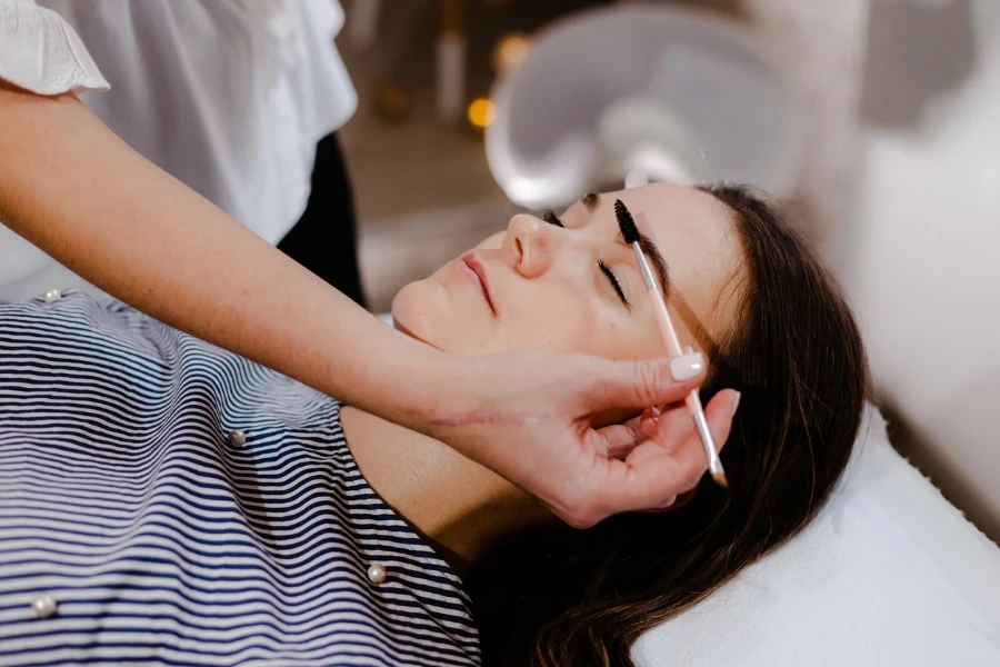 Young woman on eyebrow correction in cosmetology clinic
