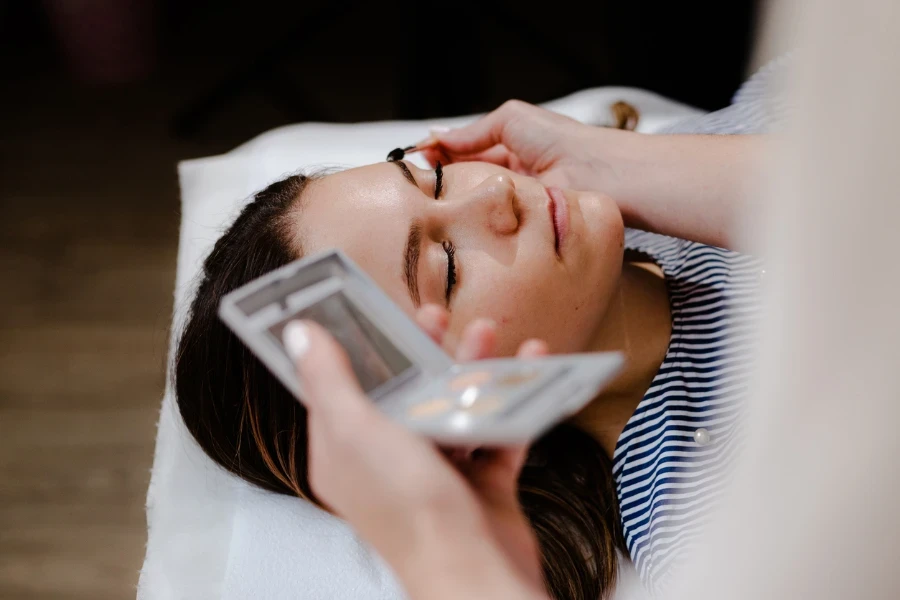 Young woman on eyebrow correction in cosmetology clinic
