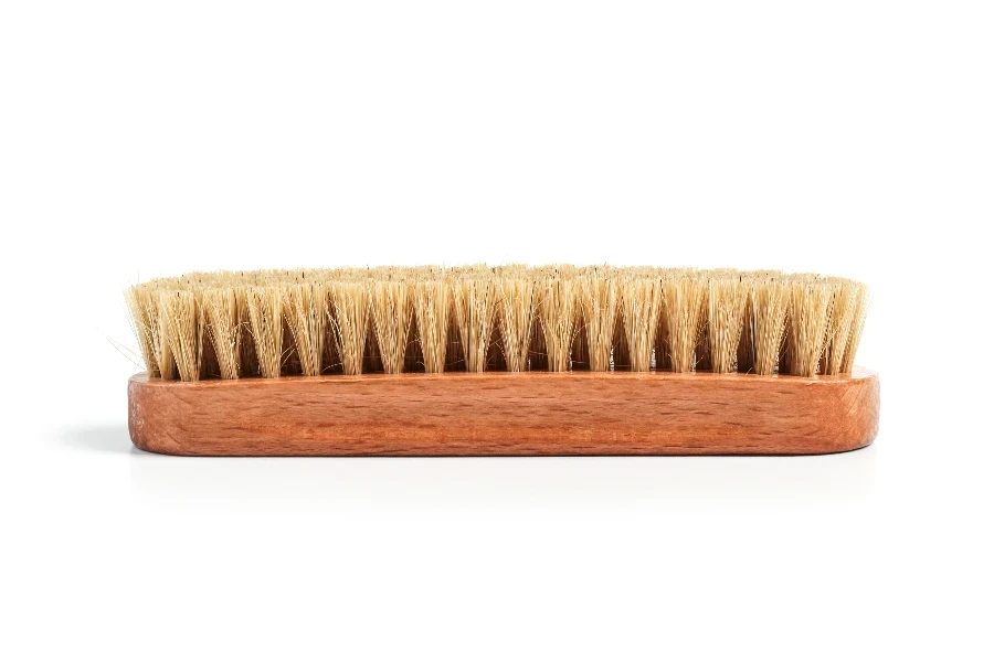 Clothing brush with wooden handle isolated on white background
