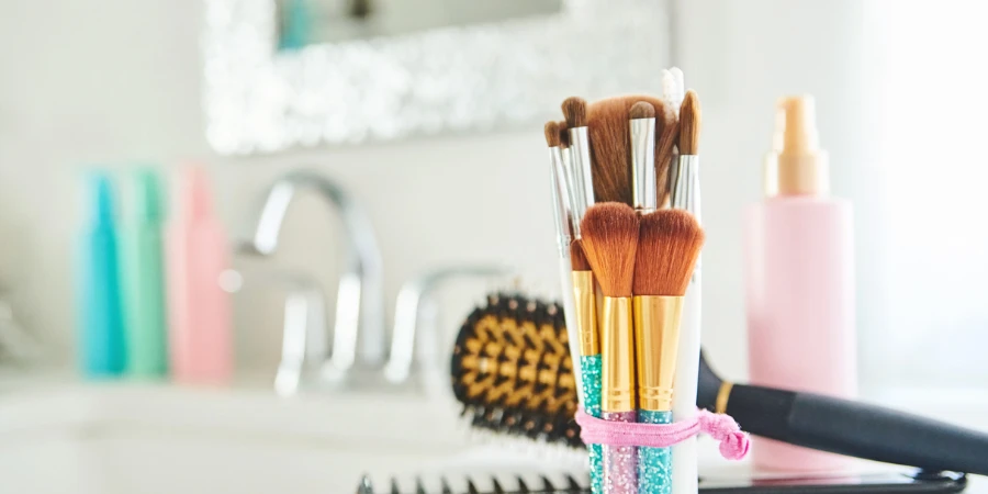 Collection of make-up brushes and personal care products in bright modern bathroom