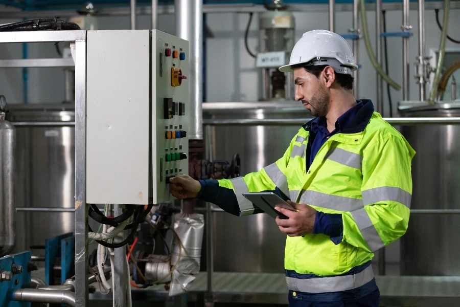 engineer or factory worker using tablet computer for finding how to use machine
