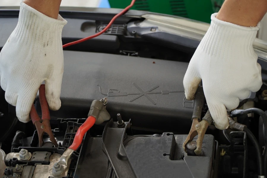 Mechanic is using electric car battery charger